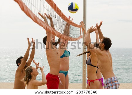 smiling american adults throwing ball over net and laughing