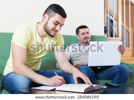 Mature professor giving private lesson to positive student at home