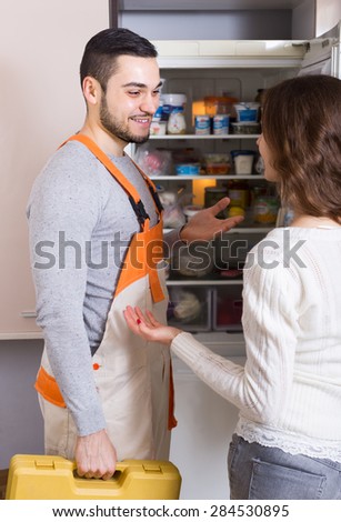 Professional workman visiting female customer for after-sales service