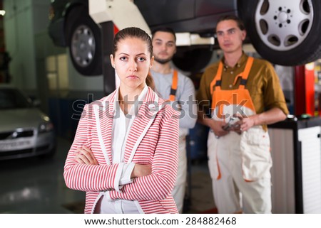 Tired unhappy female client duping by troubleshooters at auto service center