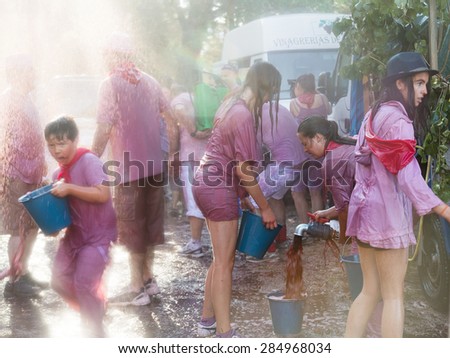 HARO, SPAIN - JUNE 29, 2014: Batalla del vino - wine madness in Haro, Spain. People fighting with wine