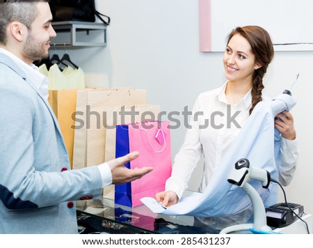 Happy cashier and satisfied customer at checkout desk