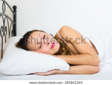 woman sleeping in underwear on white pillow