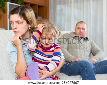Family with crying child having serious conflict at home