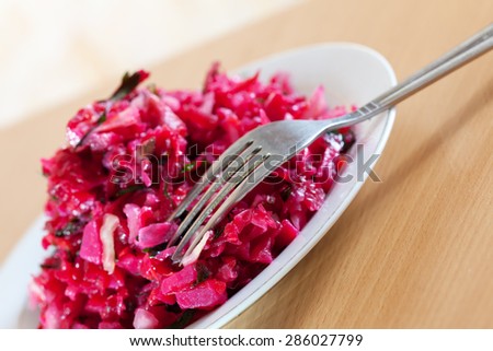 Vegetable salad from beet and cabbage in plate