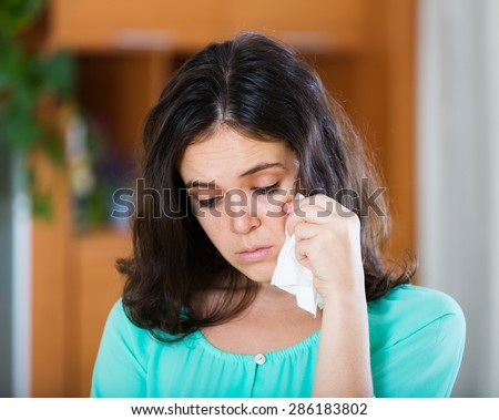 Portrait of crying woman  at  home