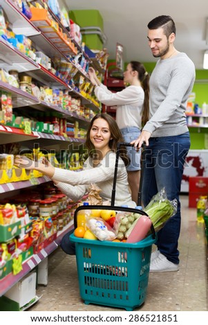 Happy customers buying food in a supermarket