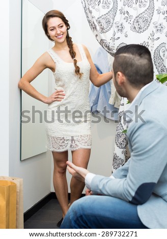 Portrait of happy smiling young couple at fitting-room in clothing store