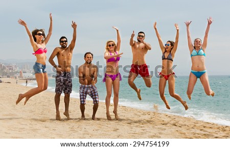 Happy people jumping at beach