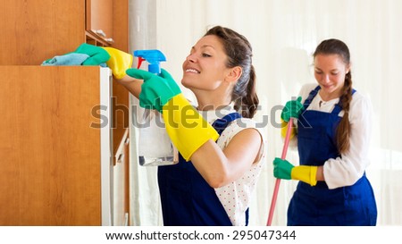 Cheerful young female workers cleaning company ready to start work