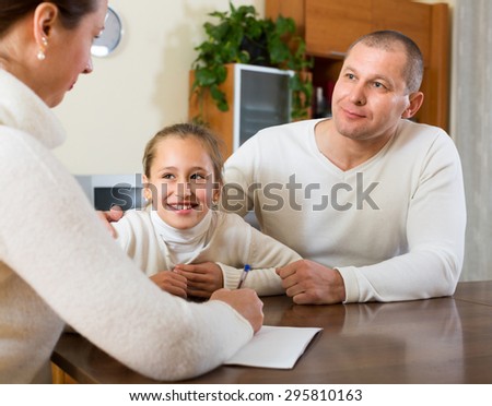 Father and daughter complete a questionnaire for the social worker
