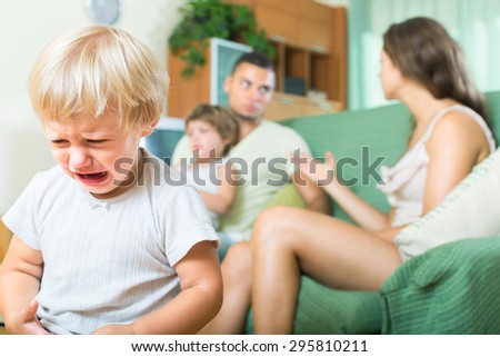 Little child crying due to a quarrel of parents