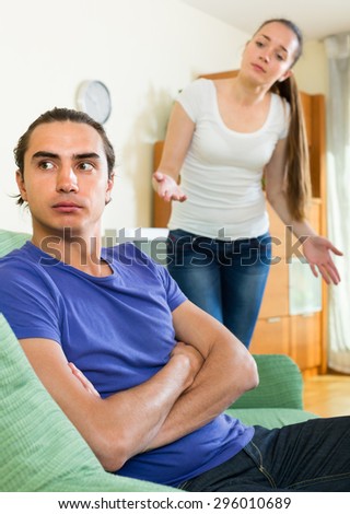 Ordinary young couple having conflict in the living room