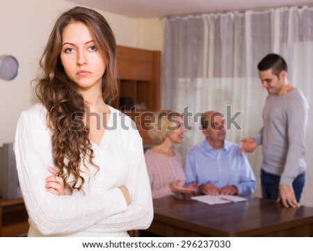 Unhappy long-haired woman fased with misunderstanding family