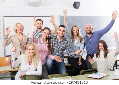 Positive professor and cheerful students in classroom at extension courses