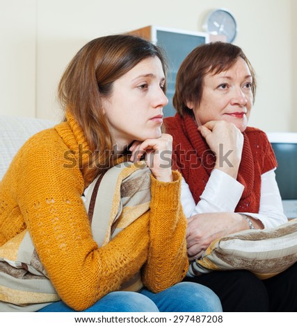 mature woman and unhappy adult daughter having problems at home
