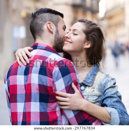 Warm welcome of smiling brunette girl and her boyfriend outside