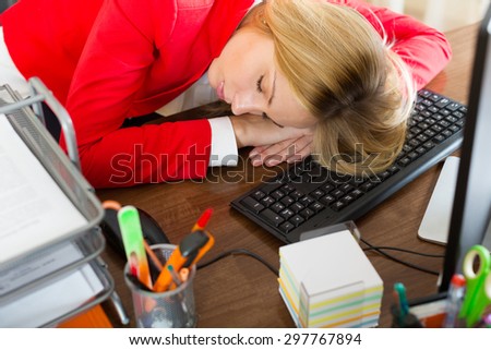 tired businessman sleeping in the office with her head on the table