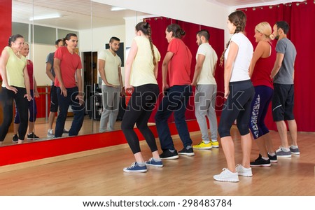 Group of men and women exercising in dance studio