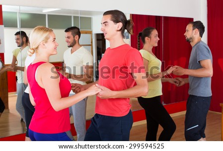 Group of american people dancing salsa in studio