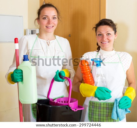 Cheerful young women workers cleaning company ready to start work