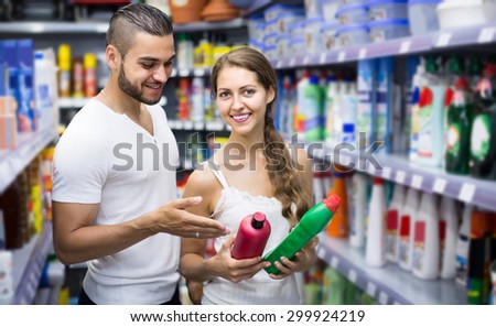 happy european people buying detergents for house in the shopping mall