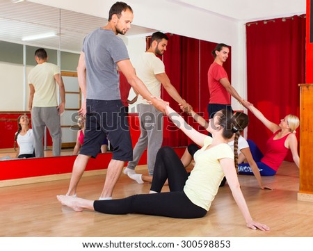 Pairs of men and women learning classic dancing moves in a dancing school