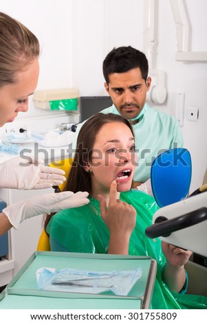 Young female patient with problems visiting dentist in the dental clinic