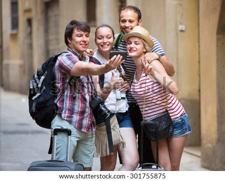 Cheerful young travelers doing selfie in the sightseeing tour. Selective focus