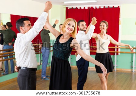 Tree young  happy couples dancing waltz in dancing-class