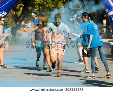 BARCELONA, SPAIN - JUNE 7, 2015: Happy dirty people running at The Color Run