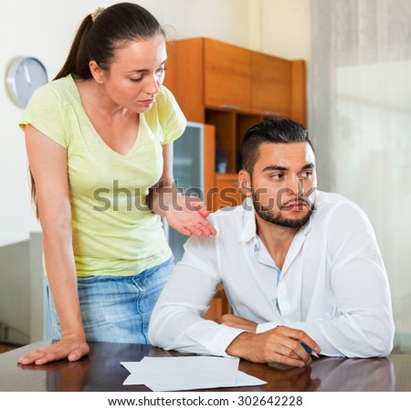 Upset dissatisfied pair discussing problems with contract at home