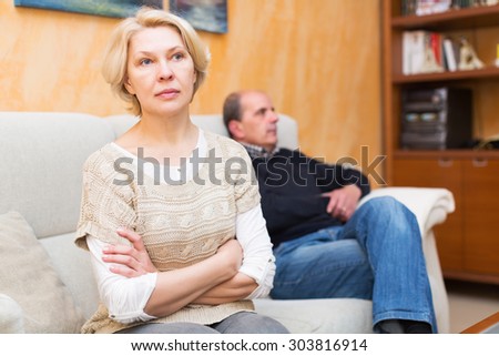 Family quarrel. Upset mature woman against elderly man at home