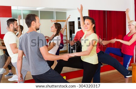 Cheerful young adults having active dance class. Selective focus
