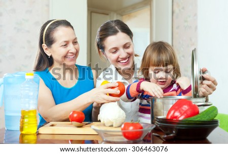 Happy family together cooking vegetarian lunch with vegetables