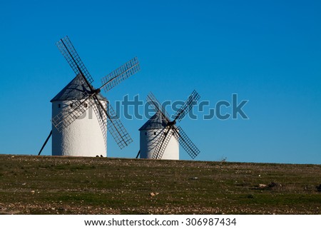 Two windmills in field. La Mancha, Spain