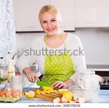 Happy woman cooking tasty apple pie at home