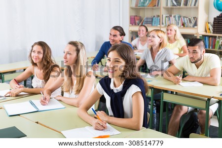 Group of attentive adult students working in a cozy classroom