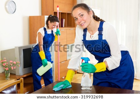 Happy adult female workers cleaning company ready to start work