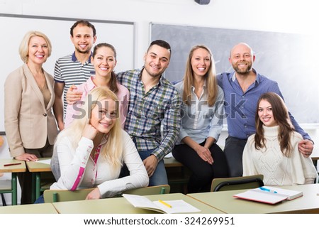 Positive professor and cheerful group of students at extension courses. Focus on girl