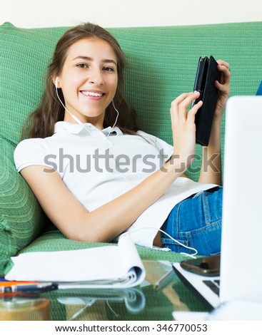 Happy young woman college student study in livingroom