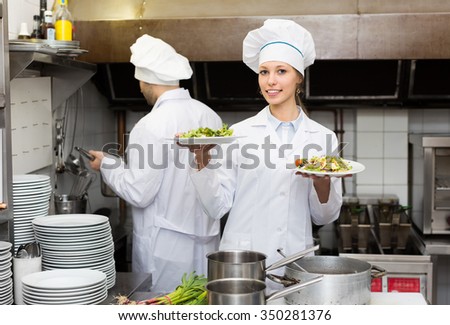 Head-cooks cooking at professional kitchen in the restaurant