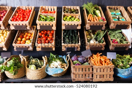view on rustic containers with various fresh vegetables and fruits in supermarket