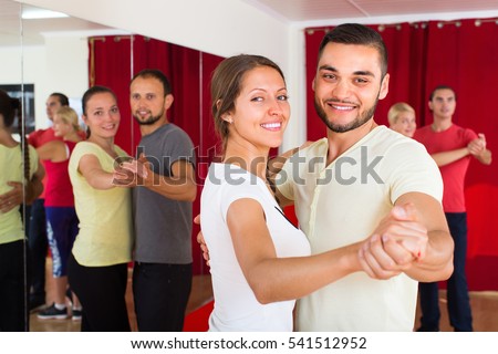 Positive happy young adults dancing pair dance