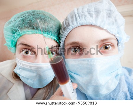wide angle shot of two young doctors with syringe