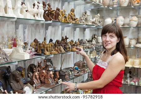 Female tourist  chooses souvenir  in egyptian shop