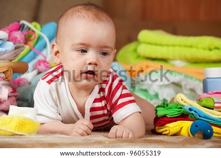 baby girl with heap of children's wear