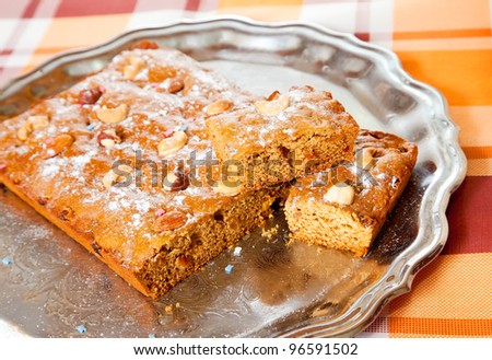 homemade fresh  honey cake with nuts on tray. The end of cooking of  honey cake.  See series