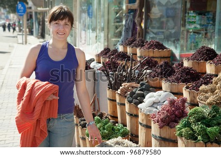woman  chooses herbs at oriental market