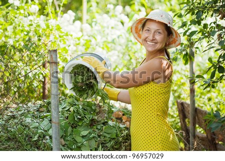 Female farmer making compost in garden